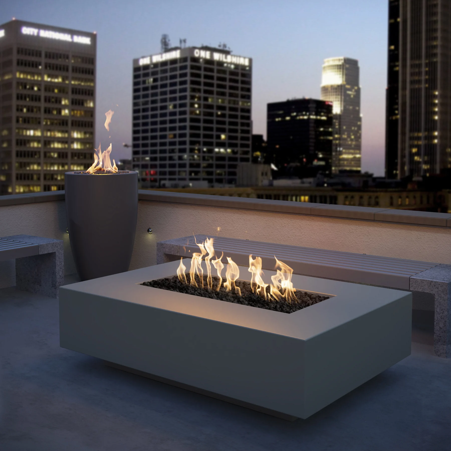 The Outdoor Plus Cabo Linear Fire Pit in an evening rooftop setting